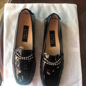 A Pair Of Black Patent Shoes